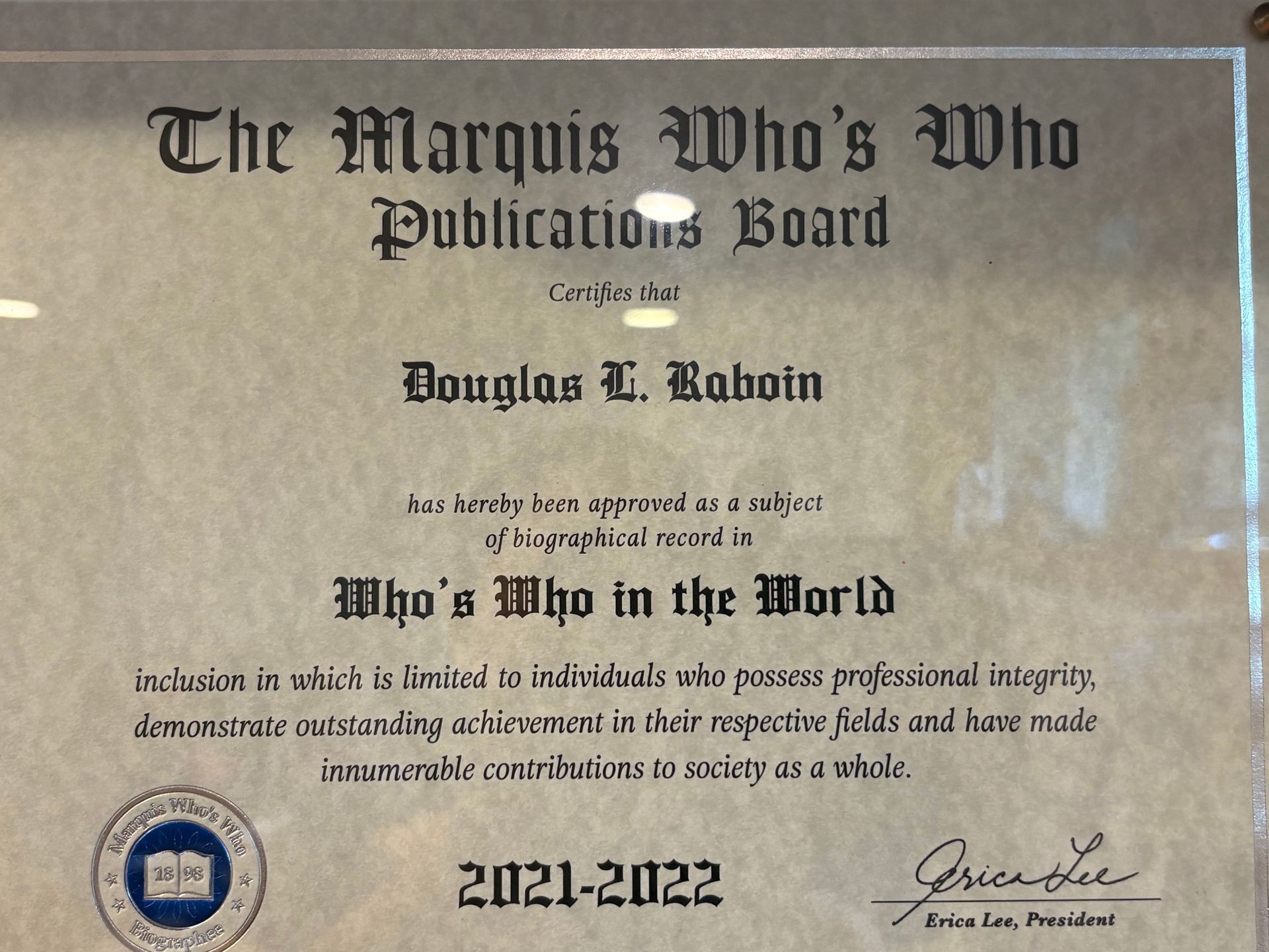 Certificate from The Marquis Who's Who Publications Board with gold seal and signed names, dated 2021-2022