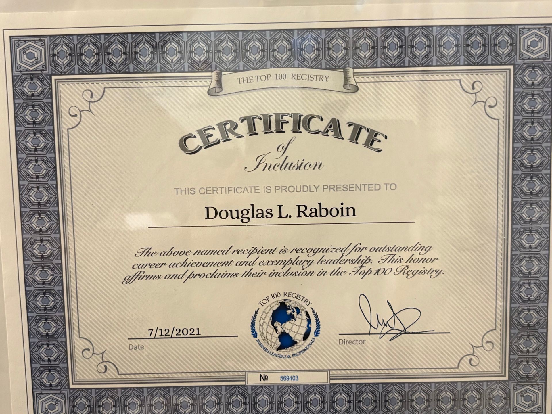 Decorative certificate with ornate border and blue seal, awarded to Douglas L. Rabon
