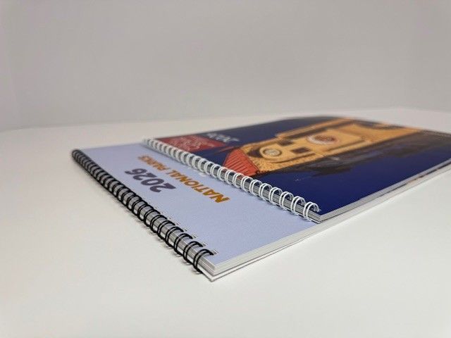 Two spiral-bound calendars on a white surface, one labeled 