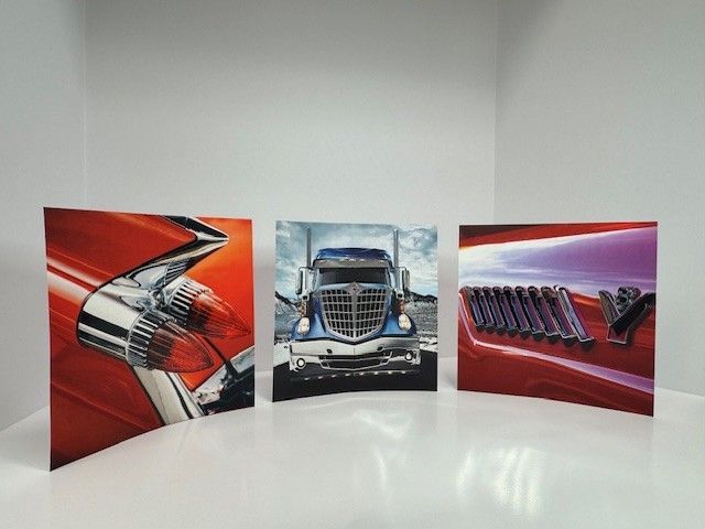 Three square canvas prints of vehicles: a red car detail, a semi-truck, and a red car detail with 
