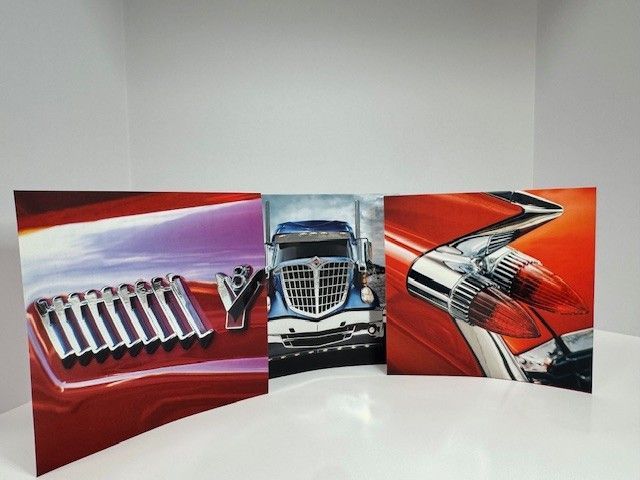 Triptych of canvas art: close-ups of red car parts and a blue semi-truck grill. Bright colors.