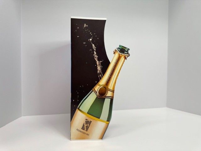 Champagne bottle cutout in front of a dark, splash-design background, set in a white studio.