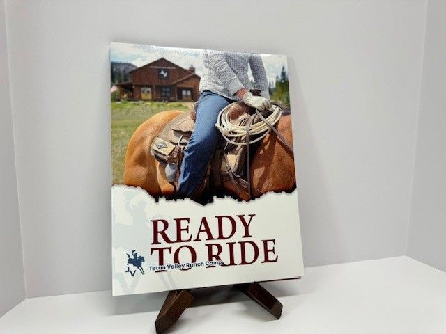 Cowboy on horseback with rope, 