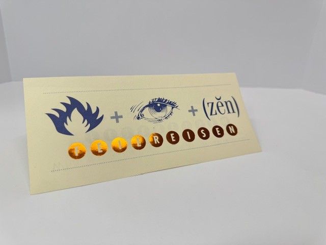 Fire + eye + (zen) and letters spelling TREISEN on a cream-colored sign.
