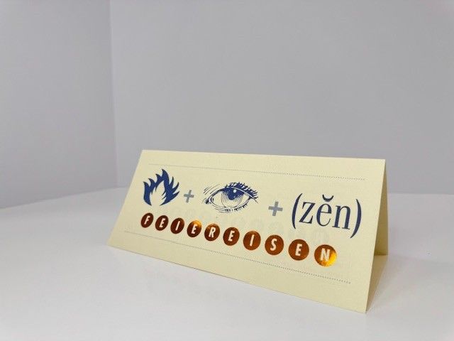 Card with symbols: flame + eye + (zen). Gold foil letters spell 
