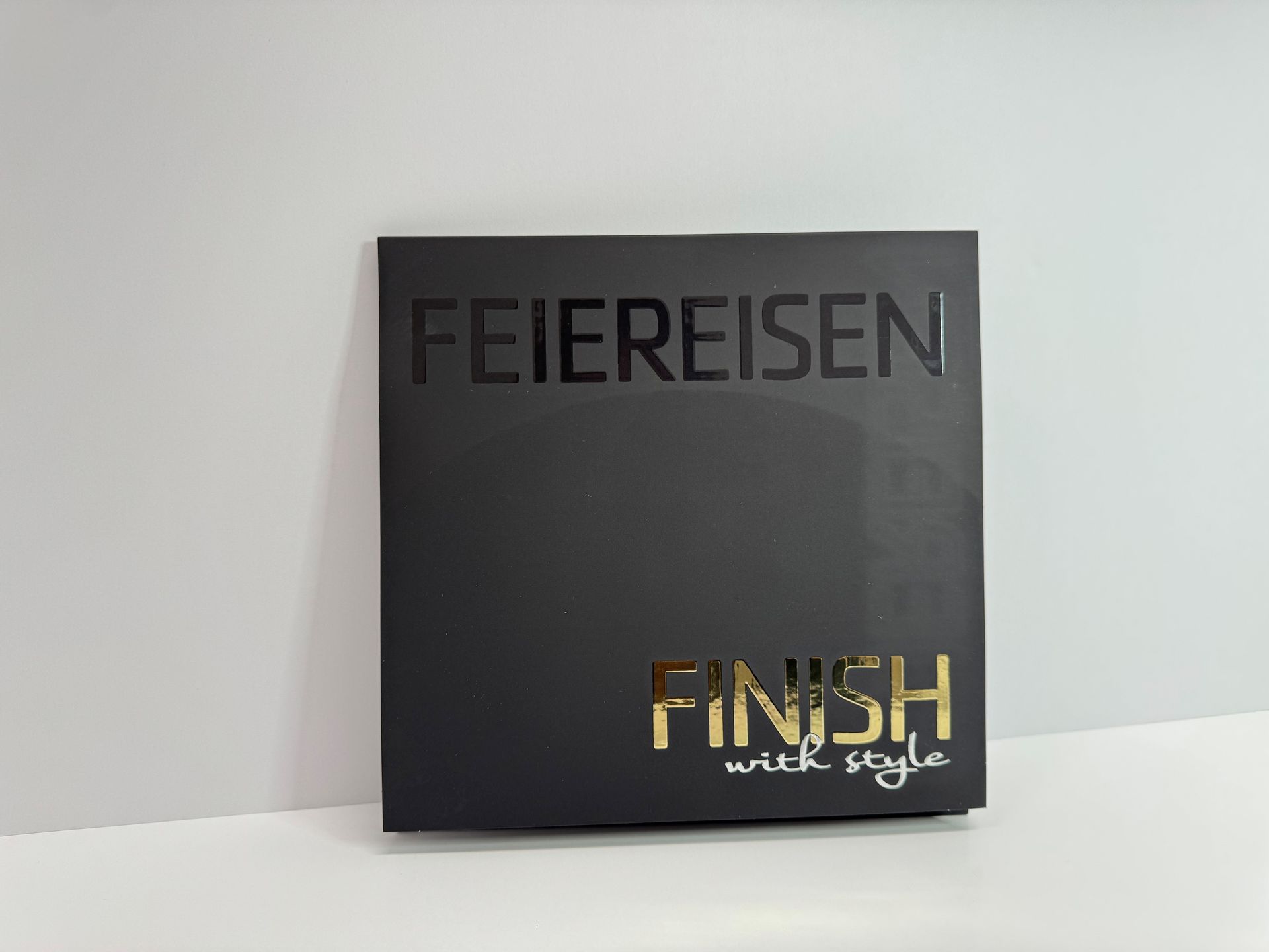 Black square box with gold lettering: 