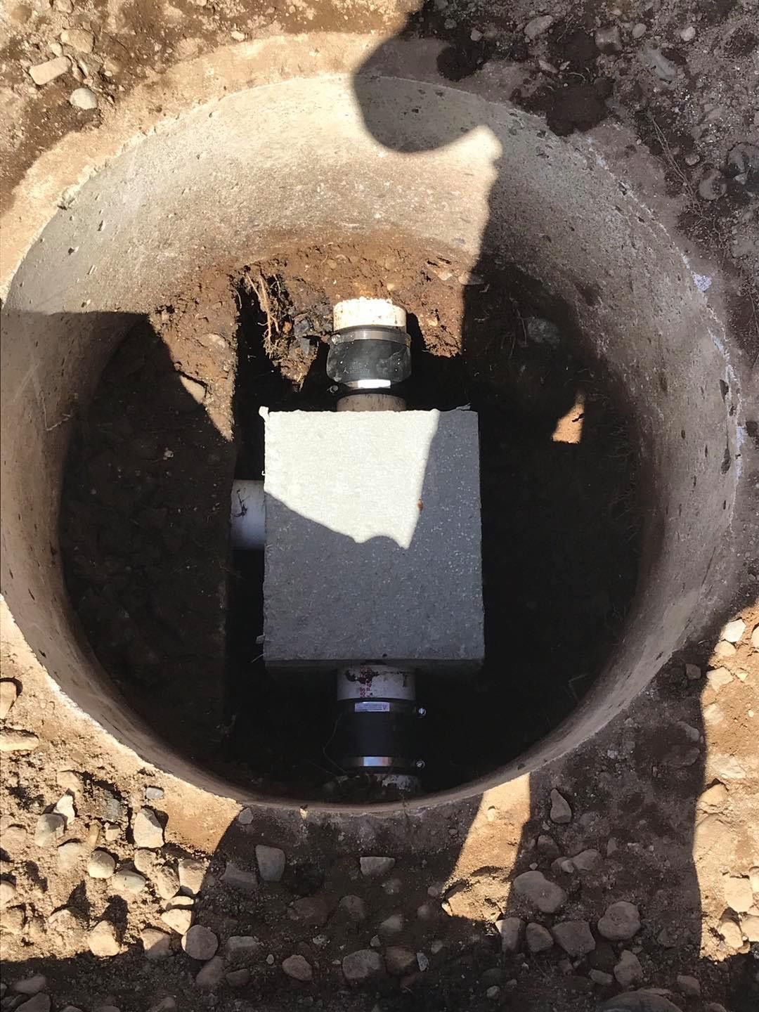 A hole in the ground with a box in it