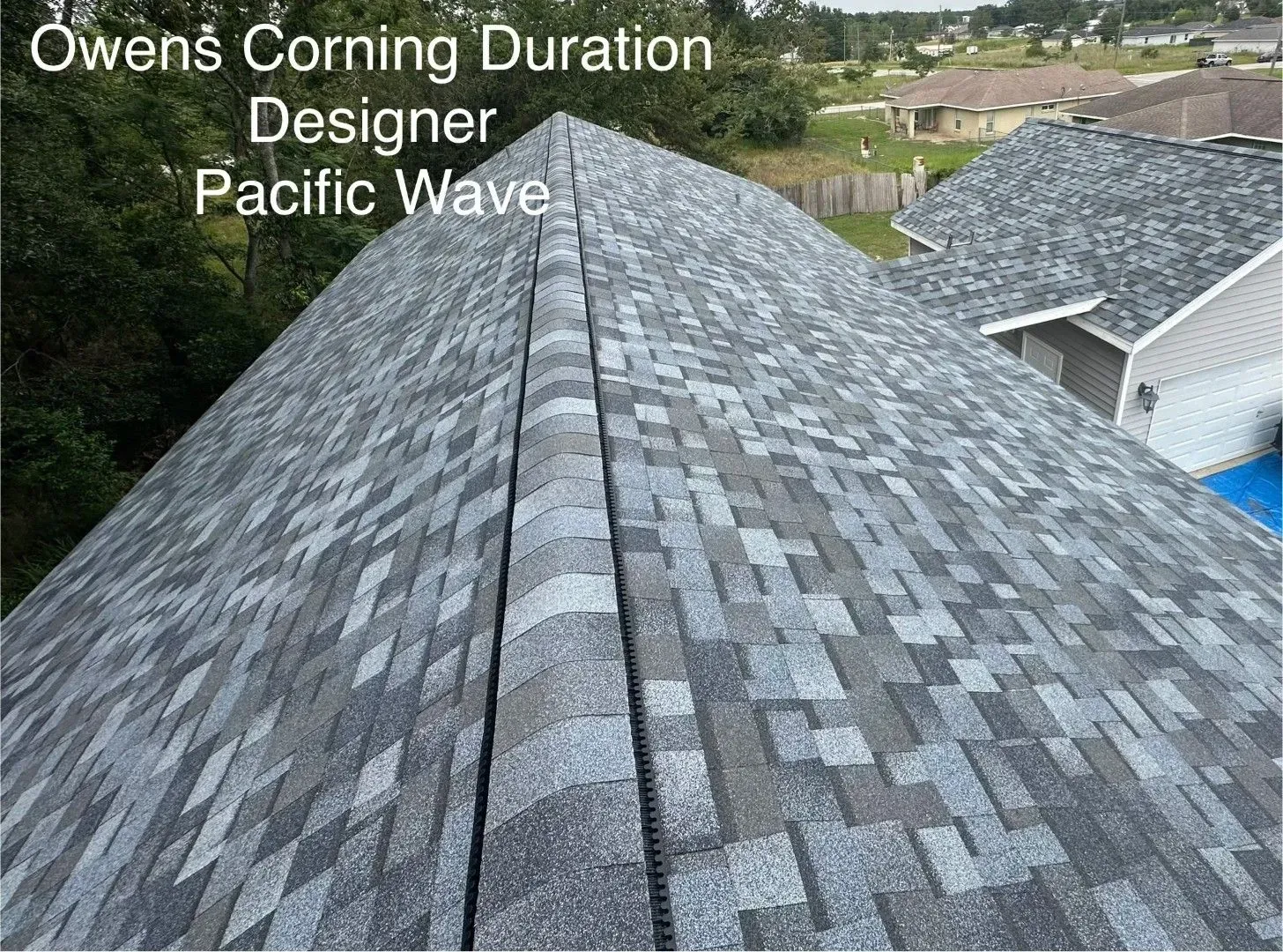 Gray Owens Corning Pacific Wave roof shingles on a house with a valley seam visible