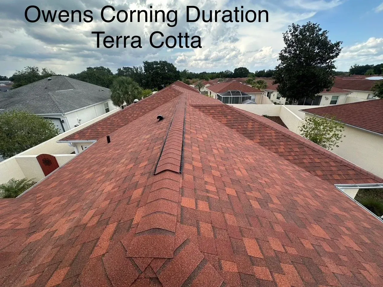 Red Owens Corning Duration Terra Cotta shingle roof on a suburban house