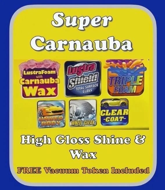 Sign advertising Super Carnauba car wash service with wax, shine, and a free vacuum token, featuring various product logos.