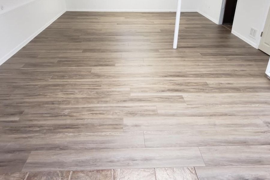 Empty room with light wood flooring and white walls, viewed from the doorway