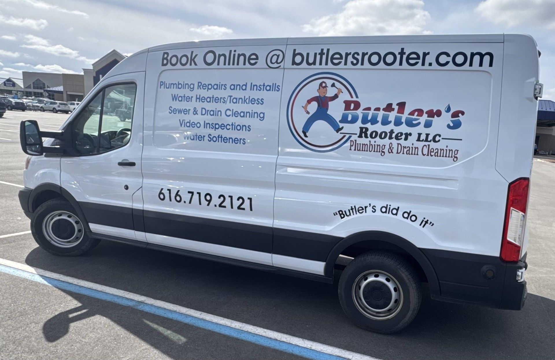 White van with Butler's Rooter logo and contact information parked in a parking lot.