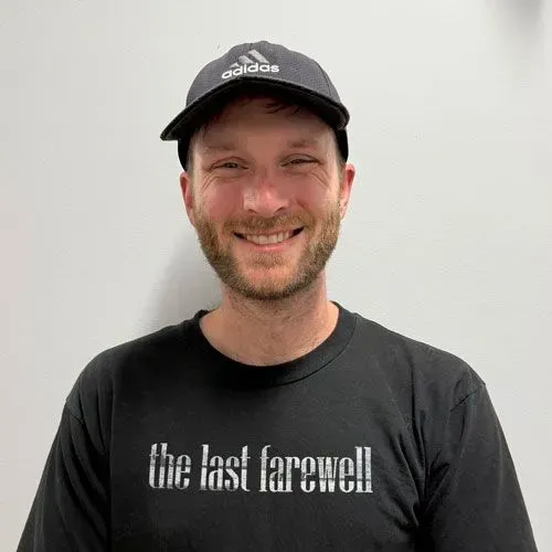 Man wearing a black Adidas cap and t-shirt with 