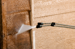 Pressure washing a wooden siding