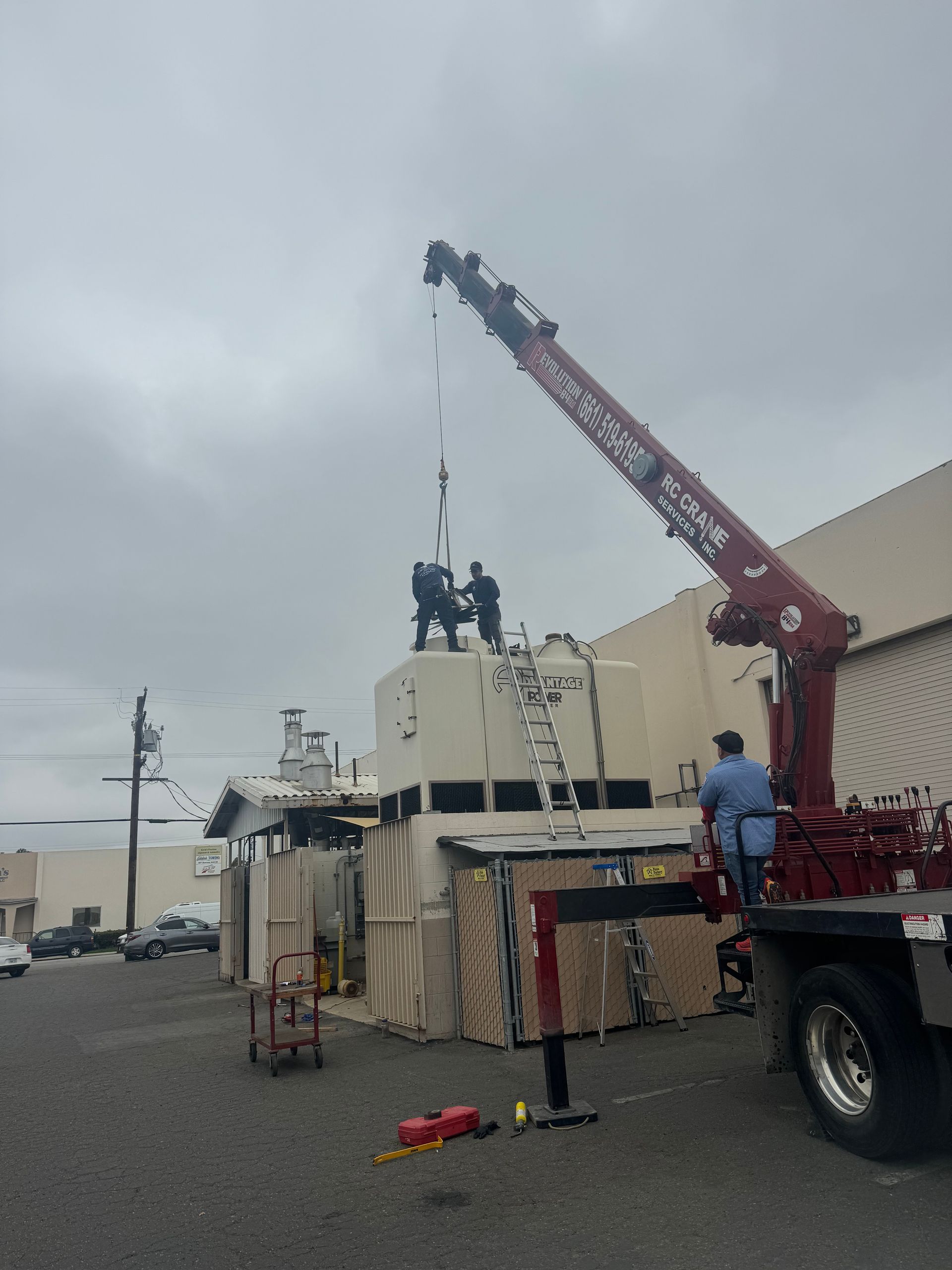 A crane is being used to lift a large box