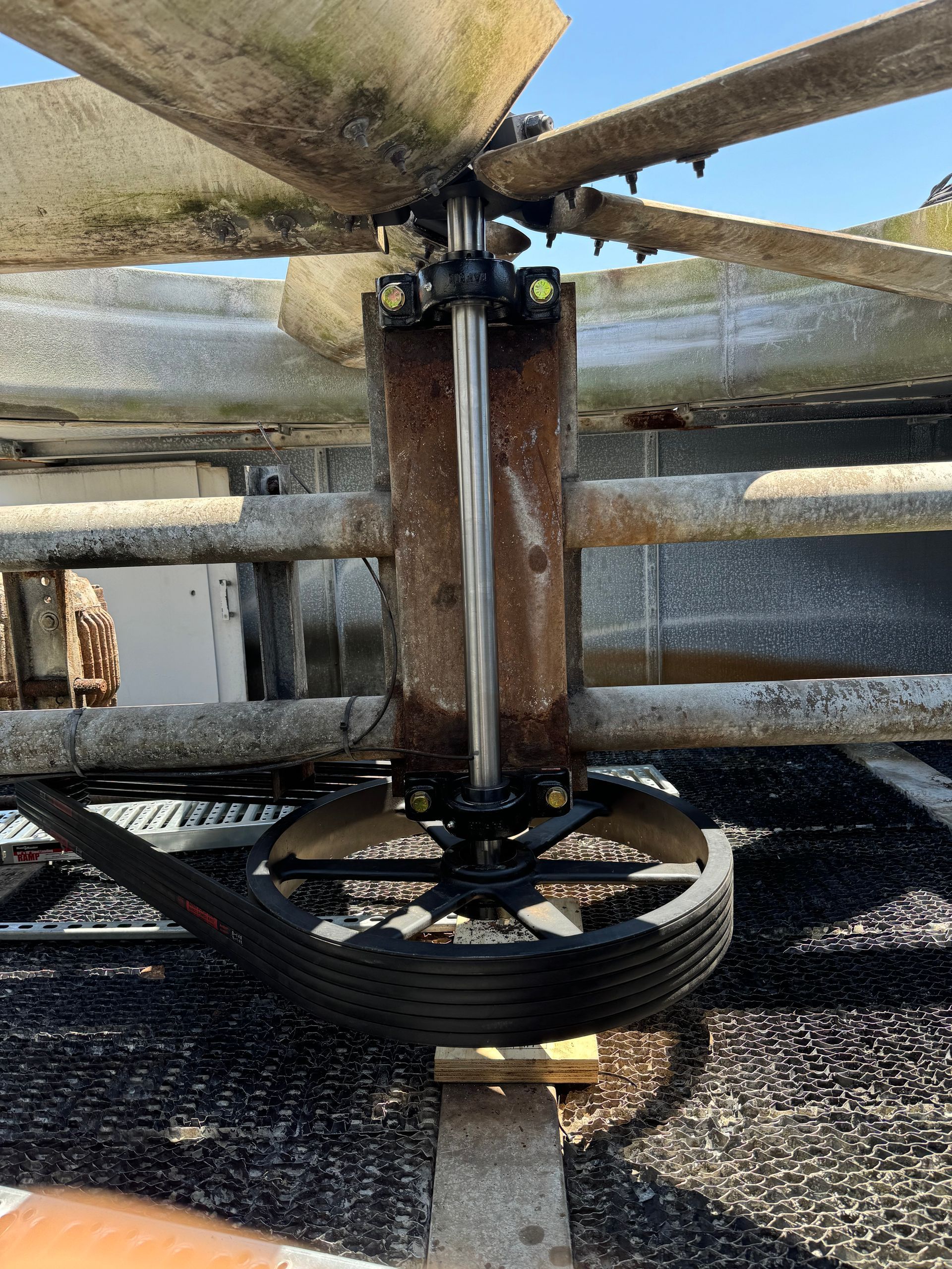 A close up of a large fan on top of a building