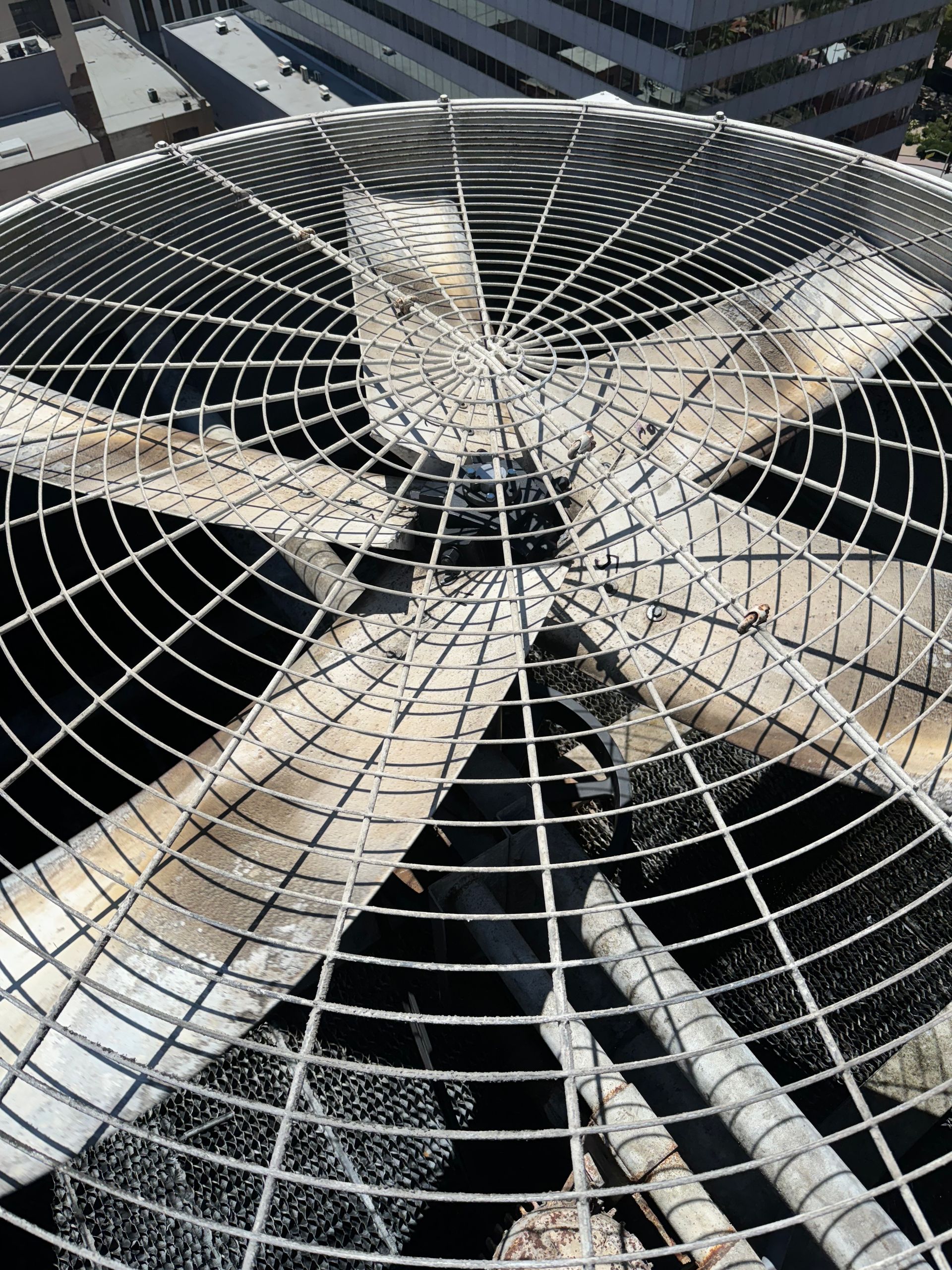 A close up of a fan on top of a building