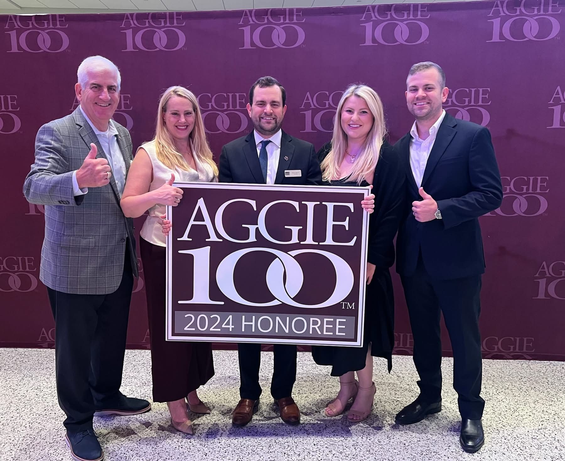 Group of five people holding a 