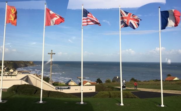 Flags of five countries waving: Normandy, France.