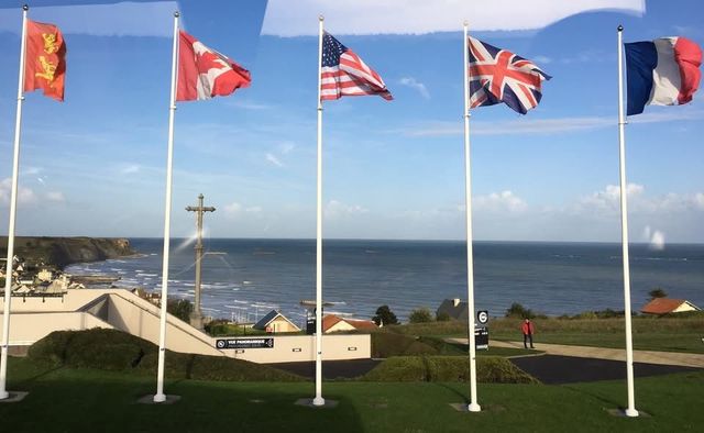 Flags of five countries waving: Normandy, France.