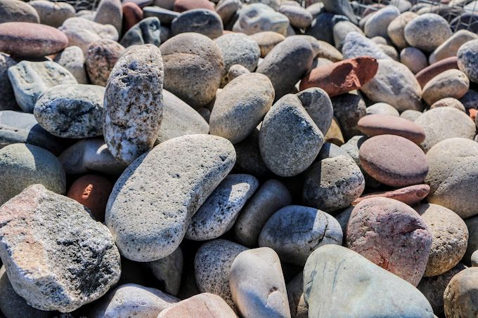 A pile of rocks sitting on top of each other on a beach.