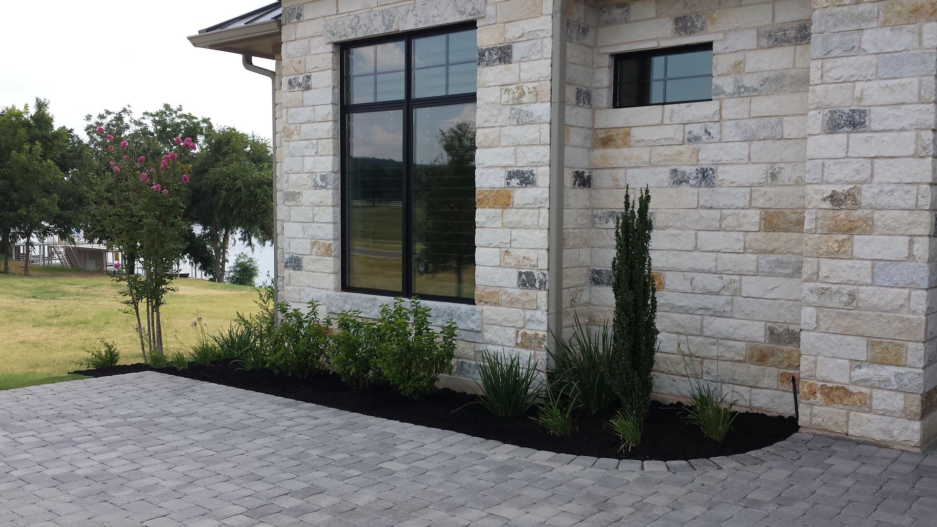 A brick house with a driveway leading to it