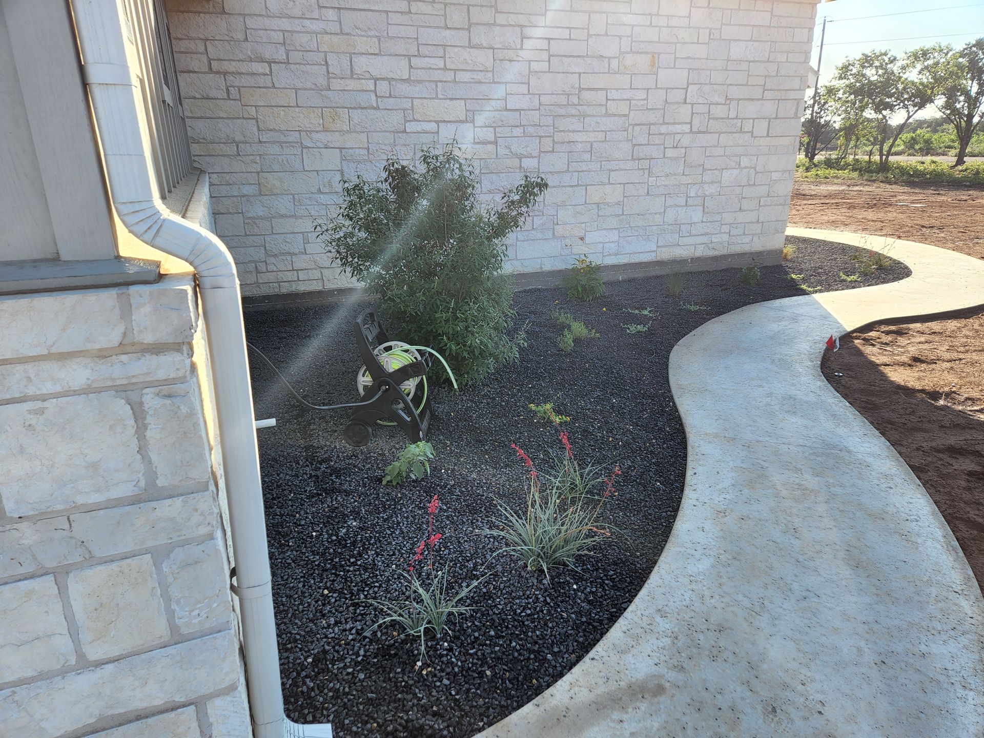 A brick building with a concrete walkway leading to it