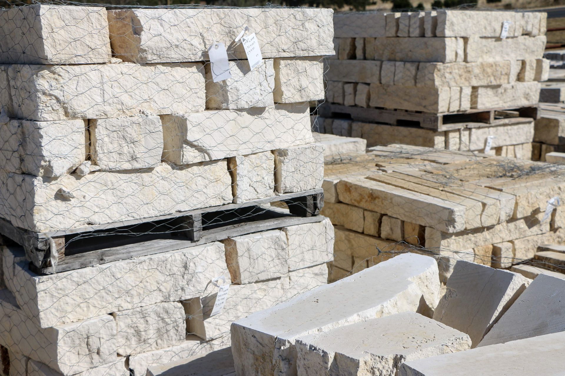 A pile of bricks stacked on top of each other on pallets