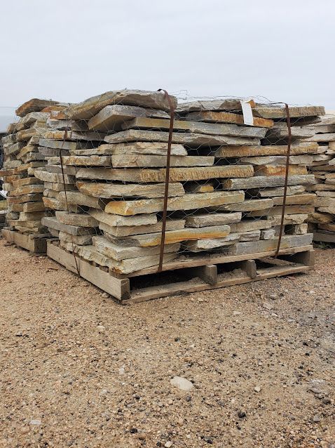 A pile of rocks stacked on top of each other on a wooden pallet.