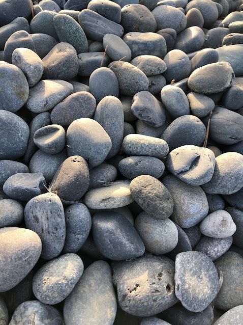 A pile of gray rocks sitting on top of each other.