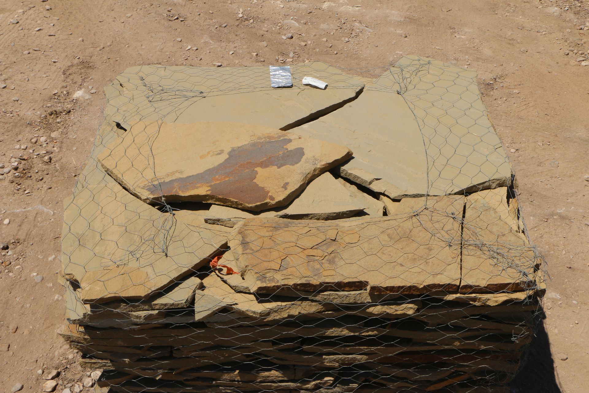 A pile of broken pieces of wood laying on the ground