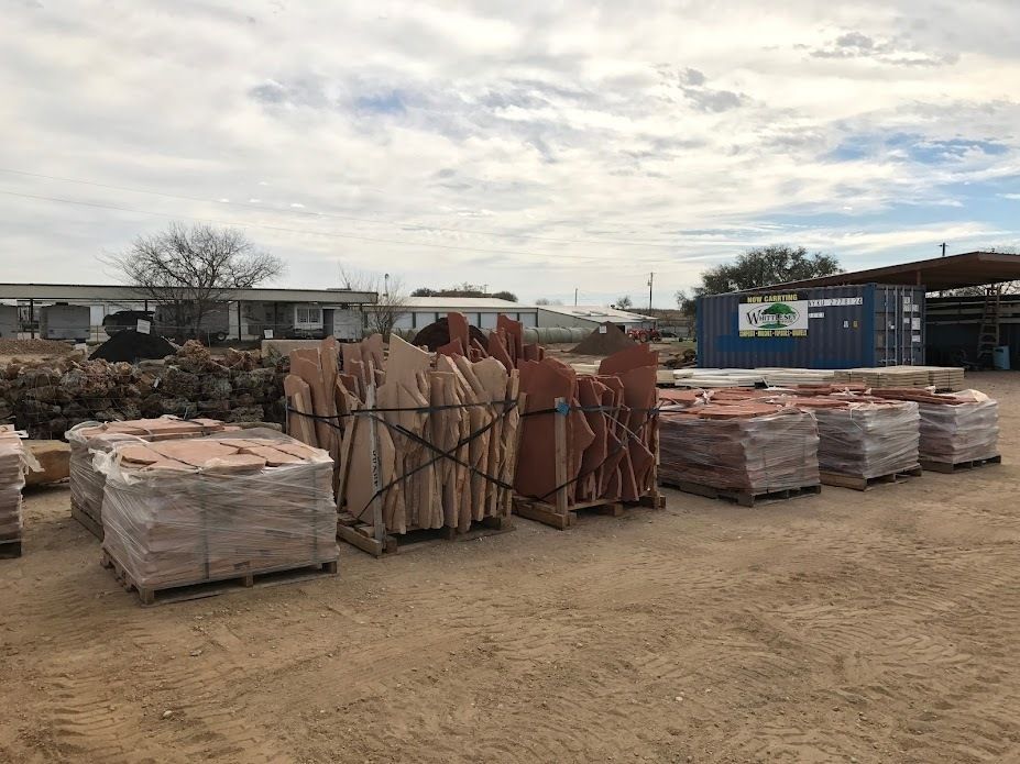 A warehouse filled with pallets of rocks and bricks.