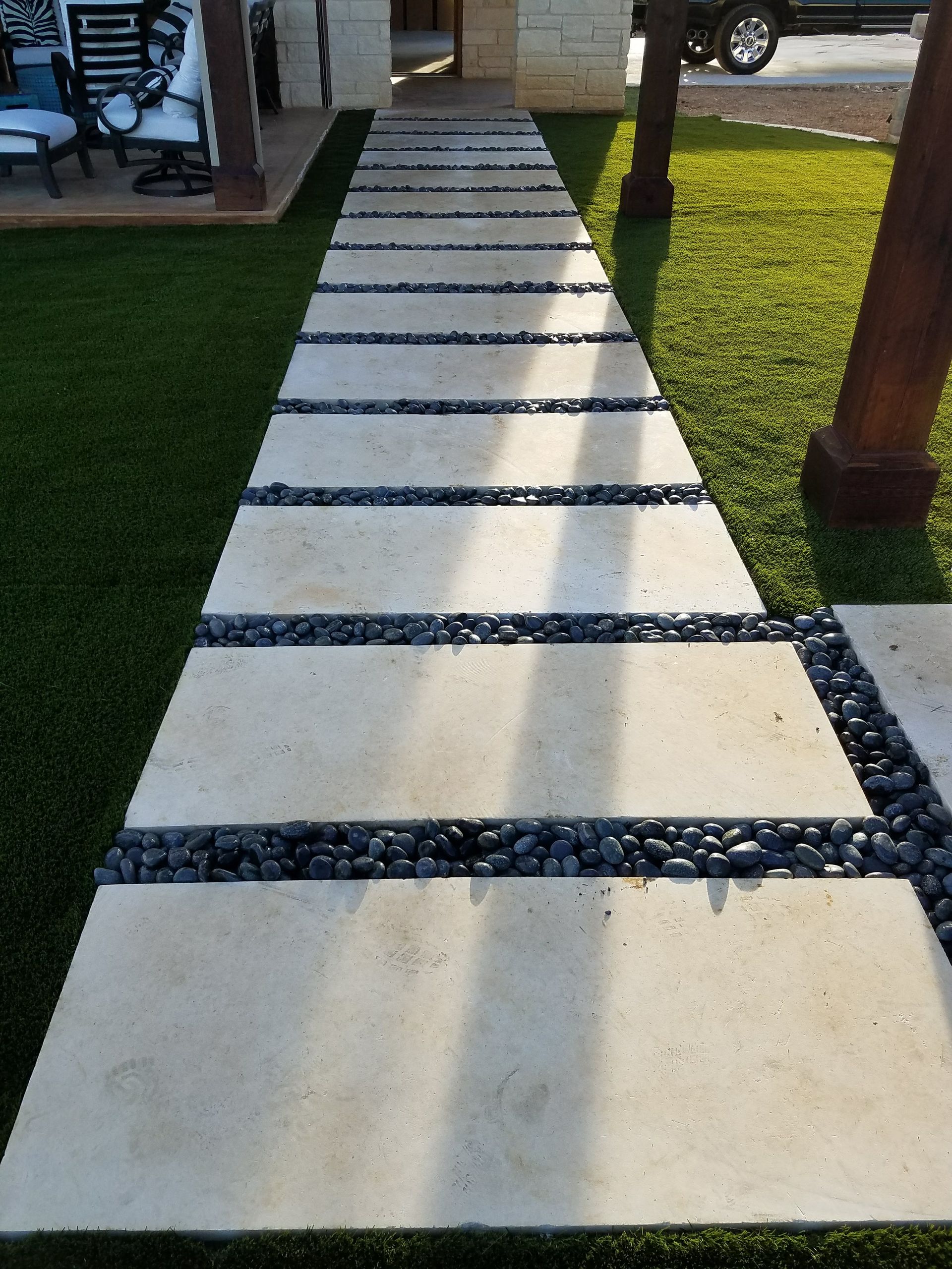 A walkway with a car parked on the side of it