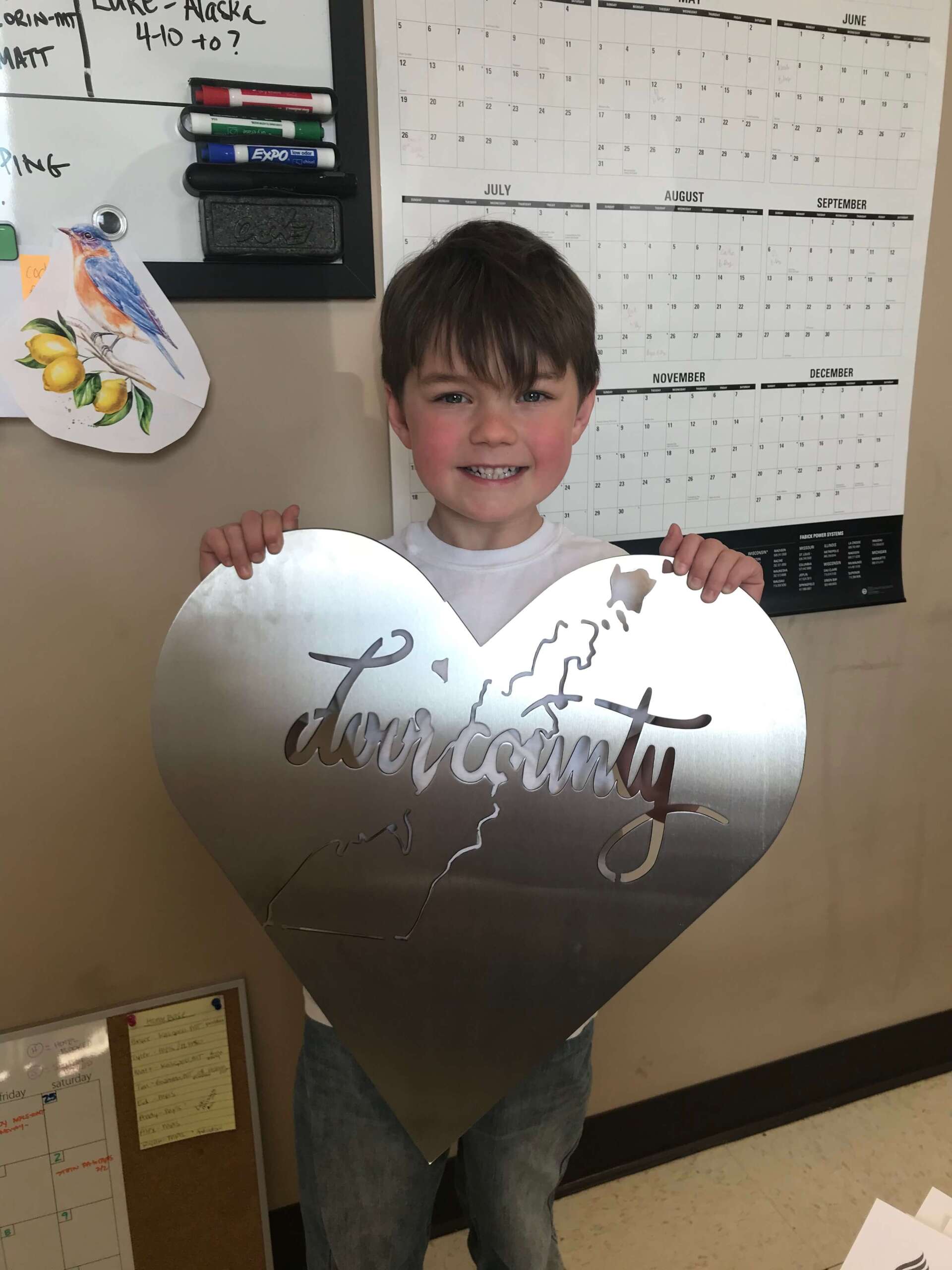 boy holding a metal art