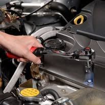 A person is pumping gas into a car engine.