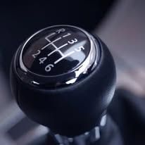 A close up of a gear shift knob in a car.