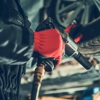 A close up of a person filling a car with gas.
