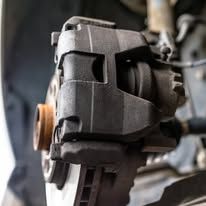 A close up of a brake caliper on a car.