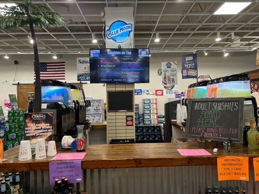 A bar in a store filled with drinks and bottles.