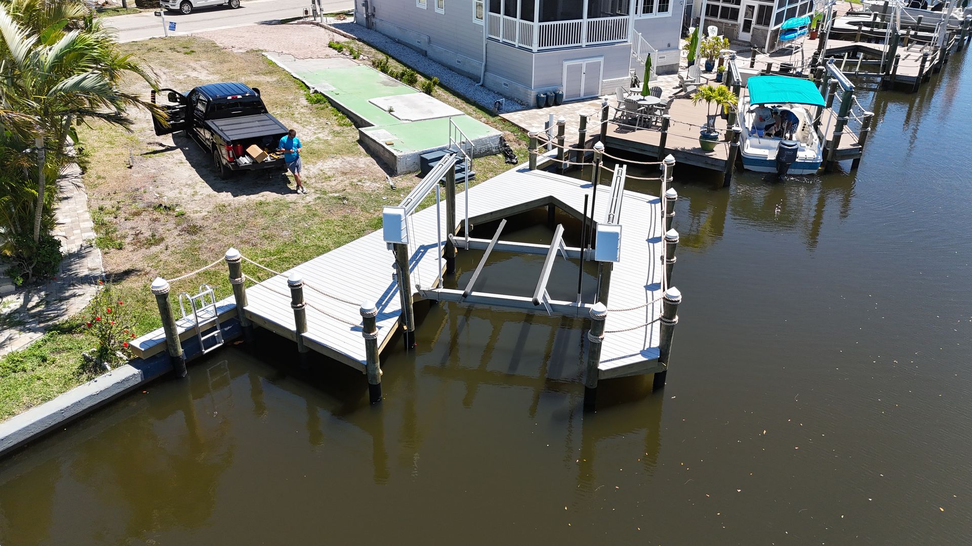 An aerial view of a dock with boats docked in the water.