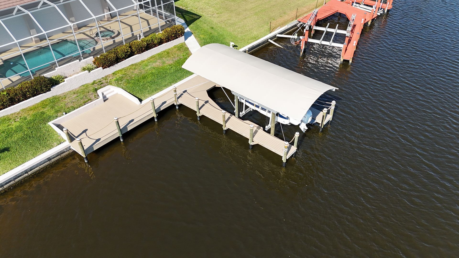 An aerial view of a boat dock in the middle of a lake.