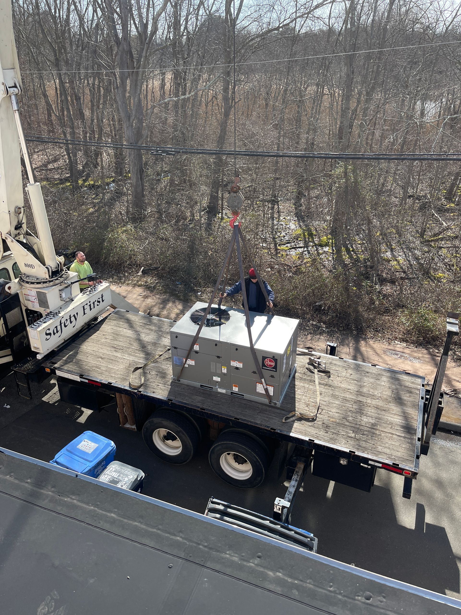 A man is lifting a box on top of a truck.