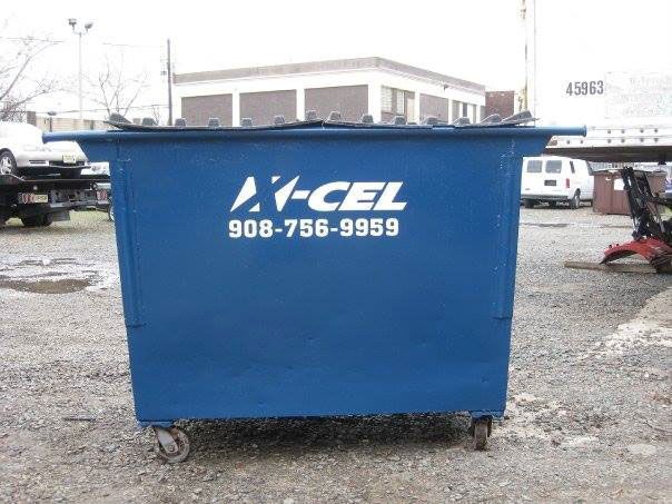 A blue dumpster with a cell phone number on it