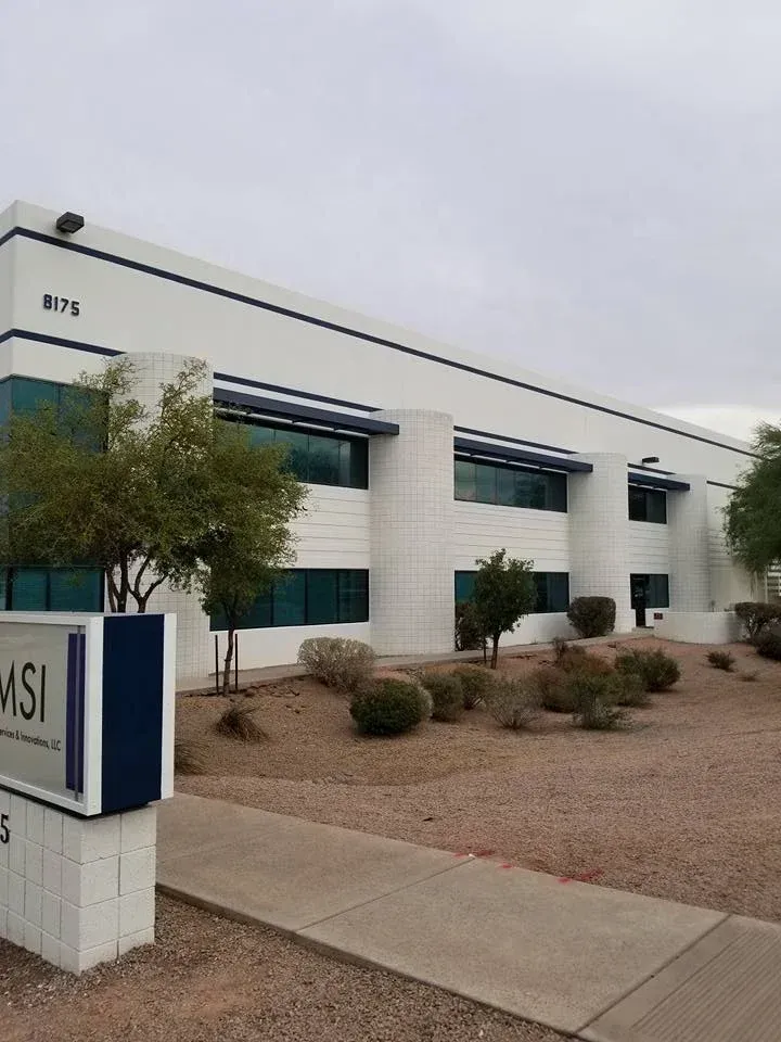 MSI office building exterior with white walls, blue windows, and desert landscaping