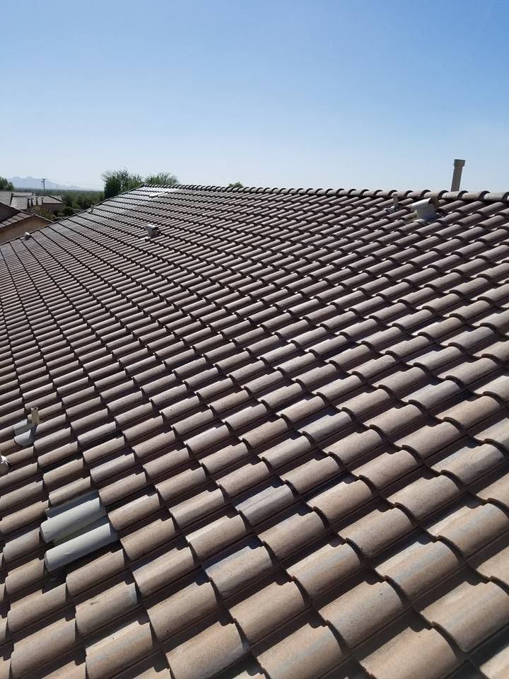 Terracotta tiled roof under a clear blue sky, seen from above