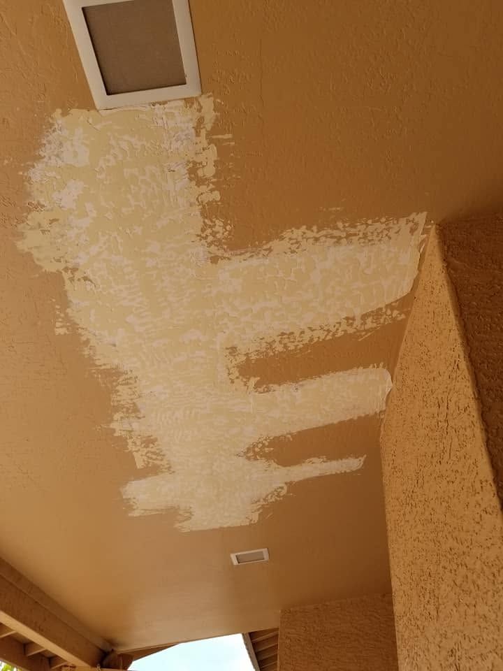Ceiling with a large white patch of fresh paint or drywall repair near a vent.