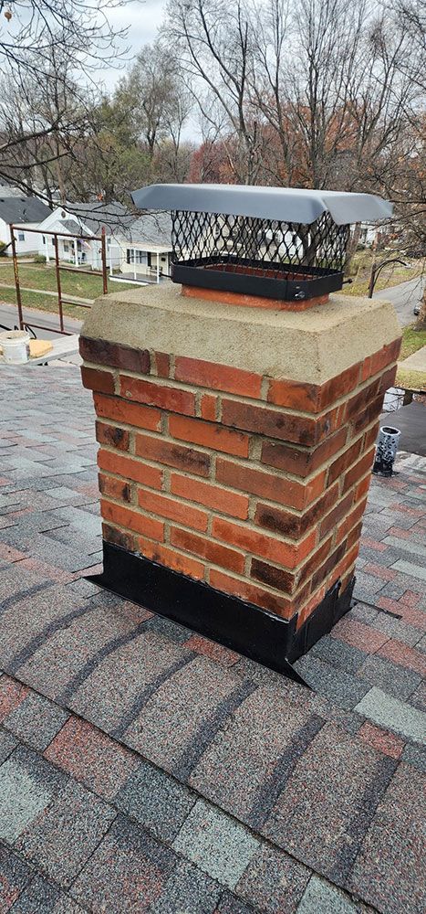 A brick chimney is sitting on top of a roof.