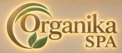 Organika Spa logo with gold text, green leaf, and circular swoosh on a beige background