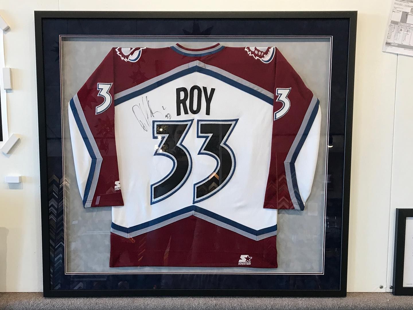 Framed hockey jersey; Colorado Avalanche, white, maroon, and navy;