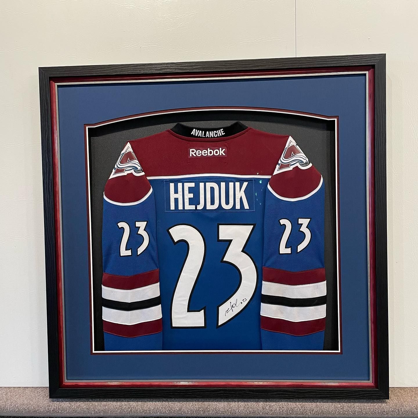 Framed hockey jersey, blue and maroon, with 